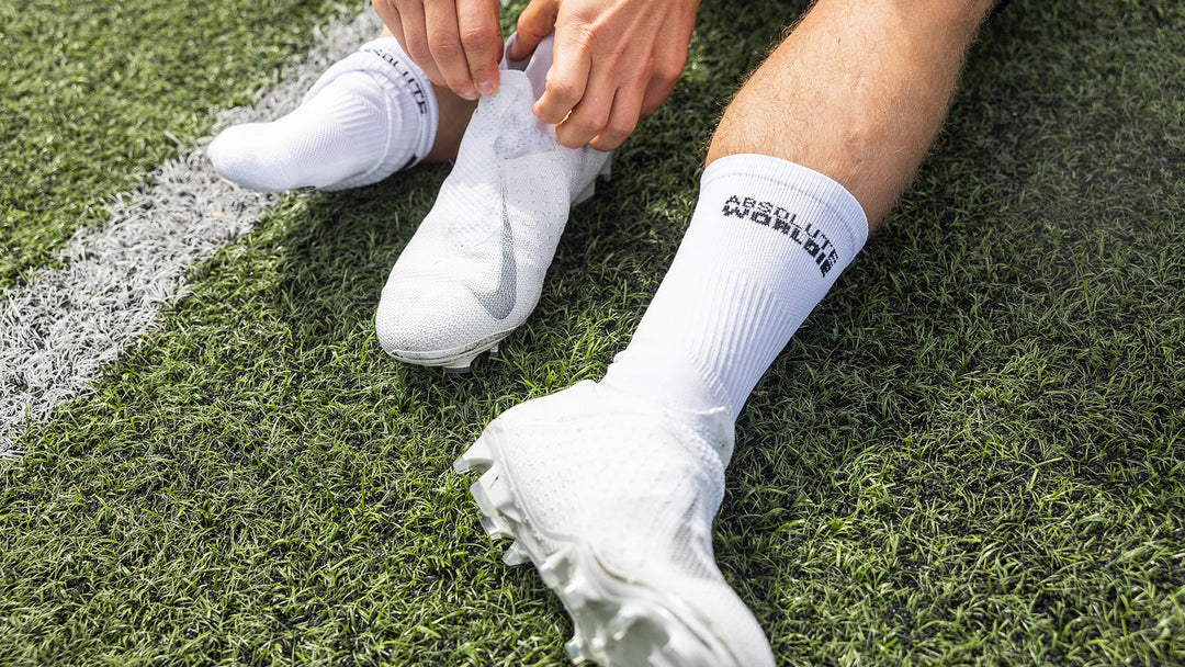 footballer putting on grip socks